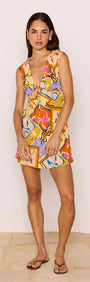 Model wearing a Bold Scarf Print Mini Dress featuring a plunging neckline and playful colorful design.