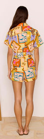 Back view of Bold Scarf Print Playsuit featuring vibrant geometric floral patterns and short sleeves.