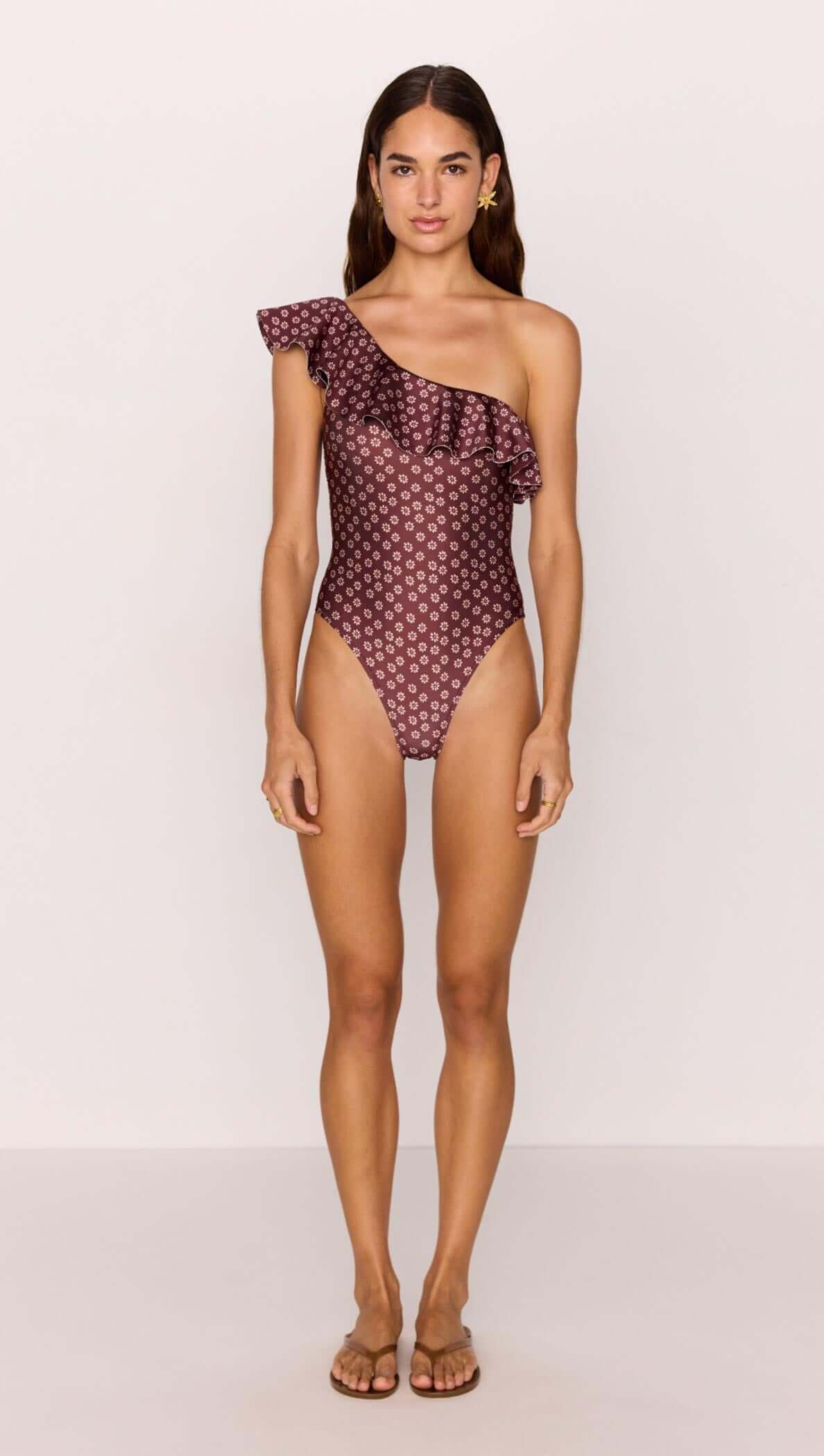 Ruffle one-shoulder one piece swimsuit in burgundy floral print, model wearing with sandals, summer fashion.