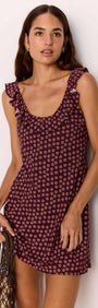 Model wearing a ruffle strap low-back mini dress in burgundy floral print, showcasing a flirty summer look.