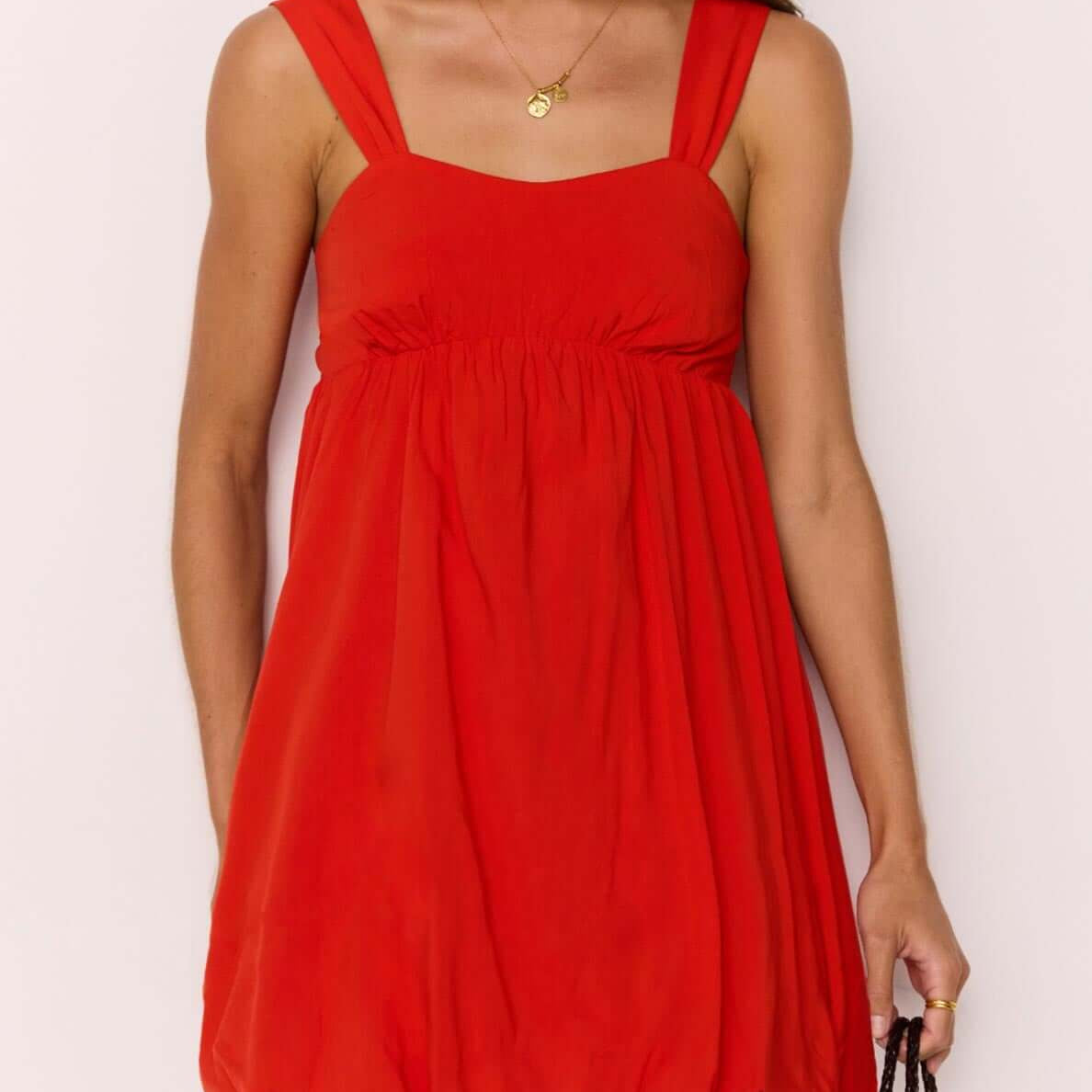 Scarlett Red Bubble Mini Dress with a soft bubble hem and gathered bust, creating a flirty summer silhouette.