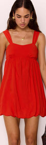 Scarlett Red Bubble Mini Dress with a soft bubble hem and gathered bust, creating a flirty summer silhouette.
