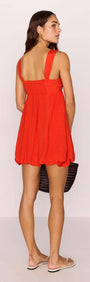 Scarlett Red Bubble Mini Dress showcased on a model from the back, featuring a bubble hem and gathered bust.