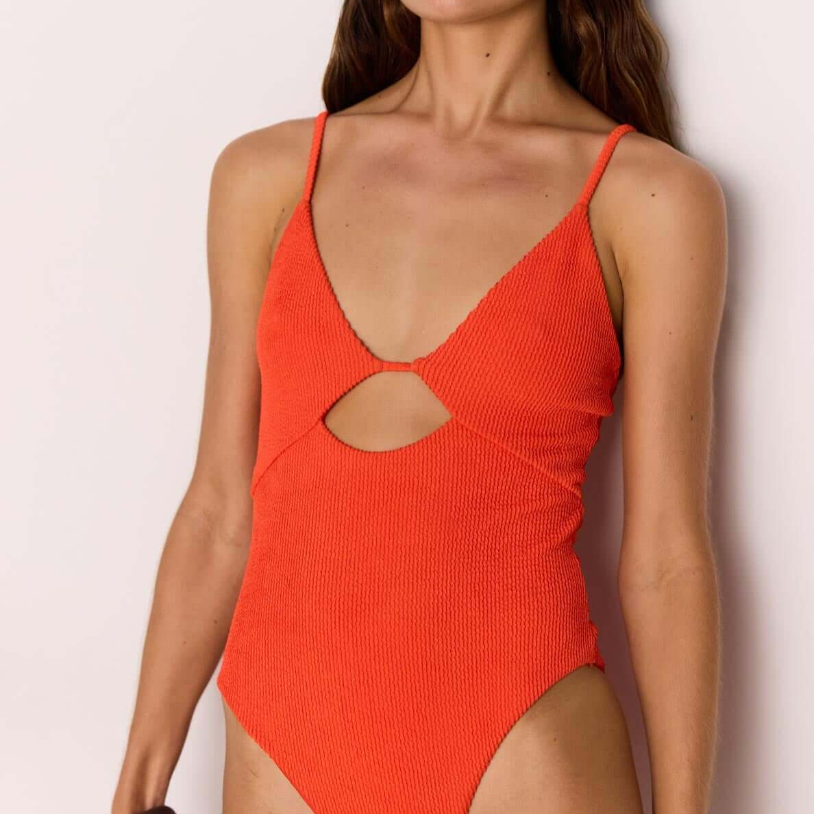 Scarlett Red Cut-Out Swimsuit on model showcasing flattering V-neckline and cut-out design.