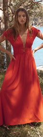 Scarlett V-Neck Midi Dress with Bead Detail in bright red worn by model near water and trees.