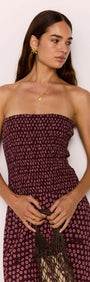 Model wearing a strapless ruched bodice dress in burgundy floral print, showcasing elegance and style.