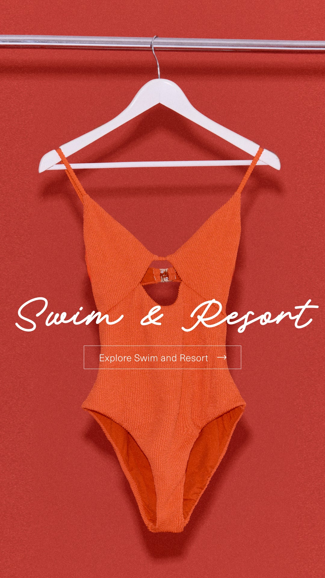 Bright orange one-piece swimsuit hanging on a hanger, perfect for swim and resort wear.