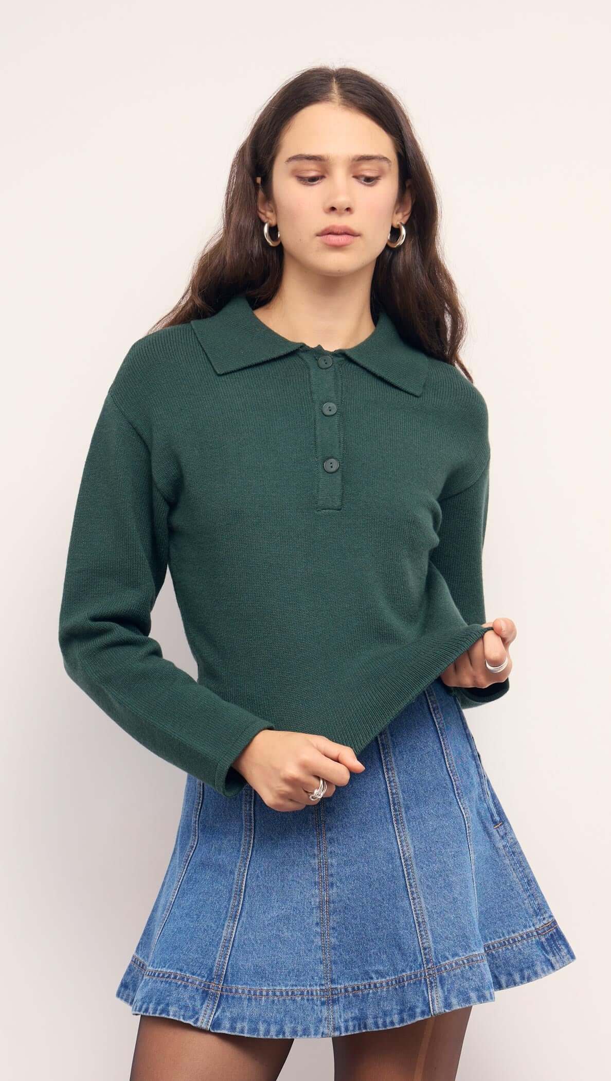 Model wearing a Teal Green Knit Polo Sweater with structured collar and button-up neckline, paired with a denim mini skirt.