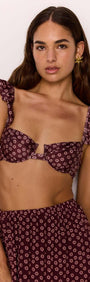 Underwire bra bikini top with ruffle straps in burgundy floral print, model wearing matching bottoms.