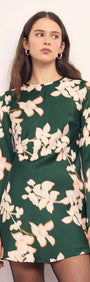 Green & Cream Floral Satin Mini Dress displayed on model, featuring a forest green base with floral patterns and long sleeves.