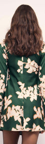 Back view of the Green & Cream Floral Satin Mini Dress featuring long sleeves and floral design.