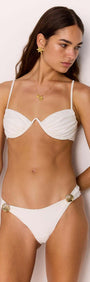Pippa Broderie Bikini Pant in white with gold shell detail, model showcasing chic swimwear.
