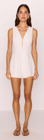 Model wearing a White Cotton Jacquard Button-Up Playsuit featuring a deep V-neckline and loop button front.