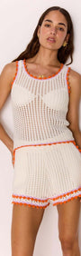 Model wearing a White Cotton Knit Top with Scallop Contrast Edge paired with matching shorts, showcasing a summer look.