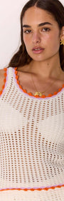 White Cotton Knit Top with Scallop Contrast Edge worn by a model, featuring open weave knit and vibrant orange trim.