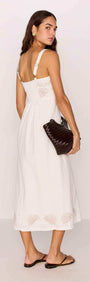 Model wearing a White Midi Dress with Embroidered Shell Detail, featuring a fitted bodice and airy A-line skirt.