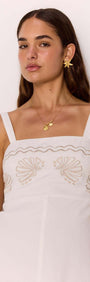 White Midi Dress with Embroidered Shell Detail showcasing delicate shell embroidery and a fitted bodice.