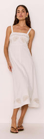Model wearing a White Midi Dress with Embroidered Shell Detail showcasing a fitted bodice and A-line skirt.