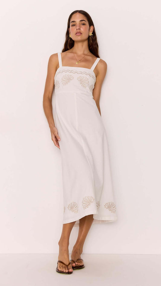 Model wearing a White Midi Dress with Embroidered Shell Detail showcasing a fitted bodice and A-line skirt.