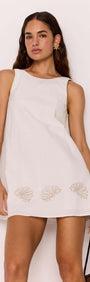 Model wearing a White Mini Shift Dress with Embroidered Shell Detail, showcasing its relaxed silhouette and shell embroidery design.