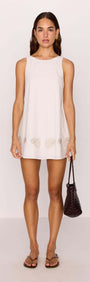 Model wearing White Mini Shift Dress with Embroidered Shell Detail, showcasing shell embroidery and a relaxed silhouette.
