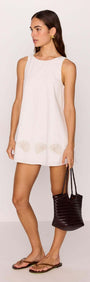 White Mini Shift Dress with Embroidered Shell Detail on model, showcasing coastal charm and relaxed silhouette.