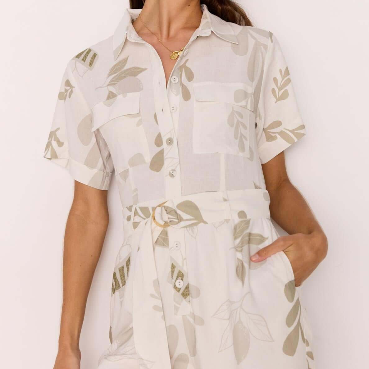 Model showcasing the White & Sage Leaf Print Playsuit with a collared neckline and matching fabric belt.