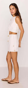 Model wearing a White Tie-Waist Crop Top paired with shorts, showcasing the adjustable tie detail and lightweight design.