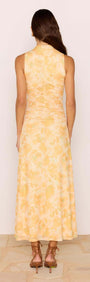 Back view of a woman wearing a Yellow Floral Mesh Midi Dress showcasing a soft floral pattern and fitted bodice.