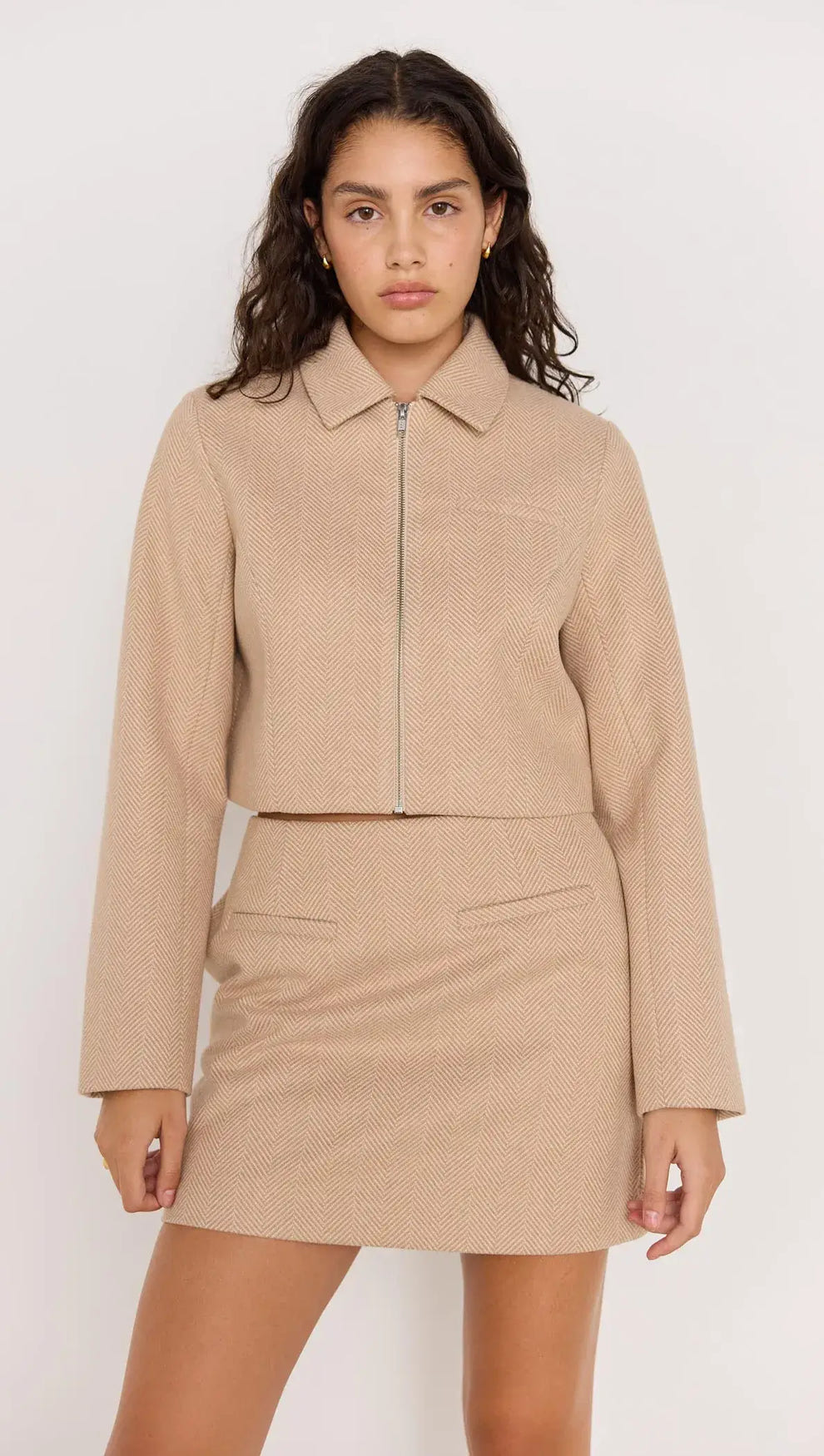 Audrey Herringbone jacket in brown shade, zipped with collar, paired with matching skirt for a chic look.