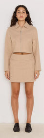 Audrey Herringbone jacket in brown, cropped with zip front, worn with matching skirt for a chic look.
