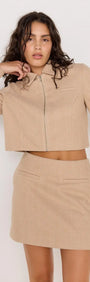 Audrey Herringbone Mini Skirt paired with matching cropped jacket in soft brown herringbone fabric.