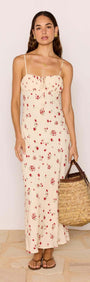 Model wearing a Red & Cream Floral Bias Midi Dress with a woven bag, showcasing a romantic summer look.