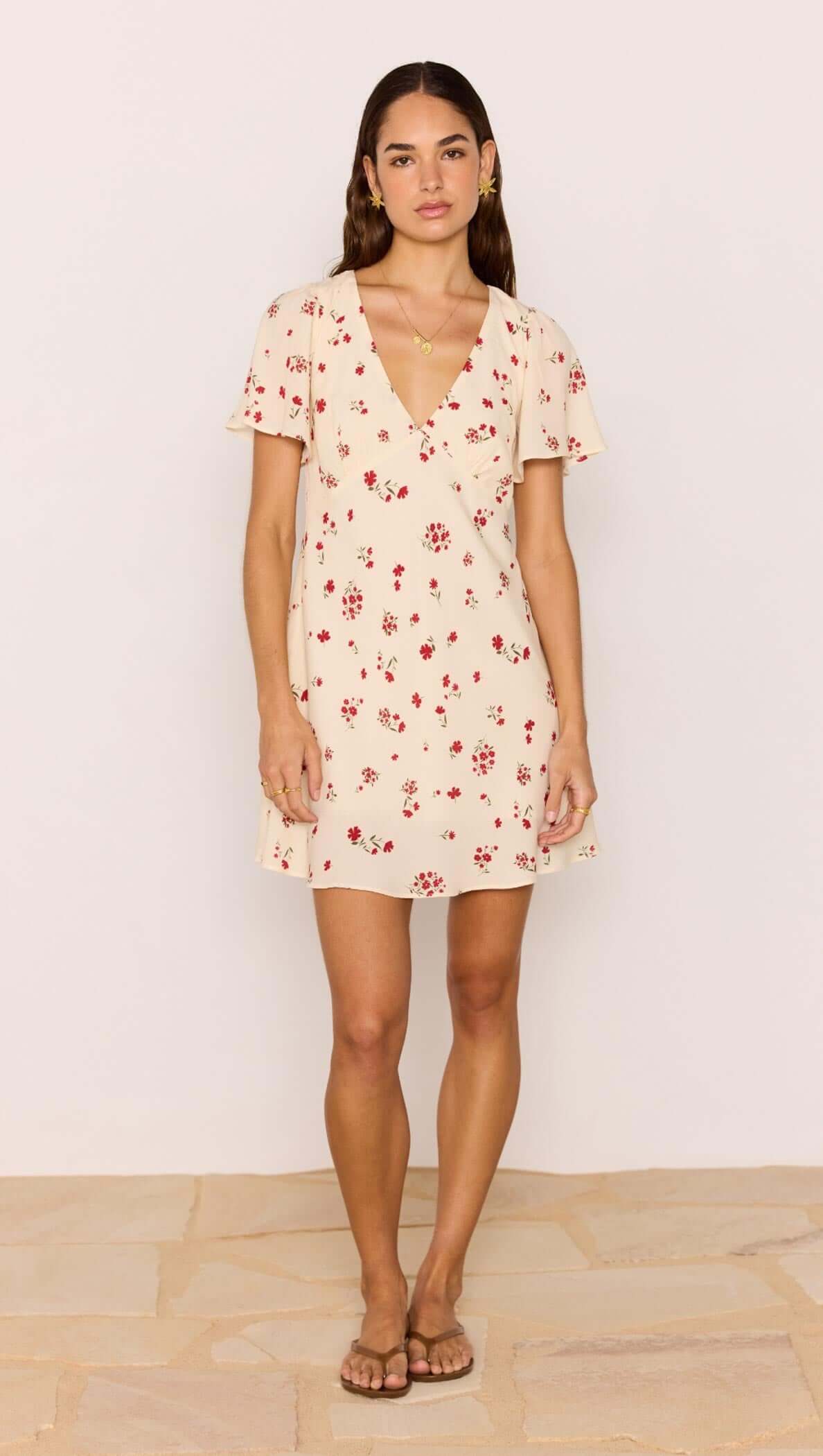 Model wearing a Red &amp; Cream Floral Mini Dress with flutter sleeves and a V-neckline.
