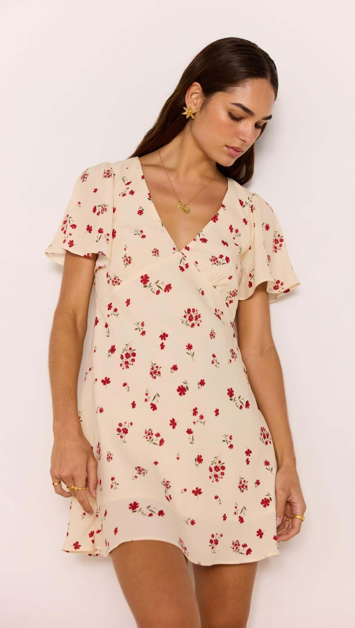 Red &amp; Cream Floral Mini Dress displayed on a model with flutter sleeves and a flattering V-neckline.