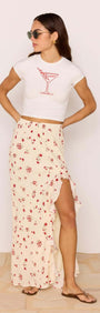 Model wearing Red & Cream Floral Ruffle Bias Maxi Skirt with a stylish crop top and sunglasses.