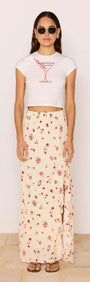 Model in sunglasses wearing Red & Cream Floral Ruffle Bias Maxi Skirt with a white cropped top.