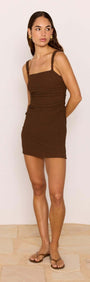 Brown Ruched Mini Dress with Bead Detail shown on model, featuring ruched detailing and a chic square neckline.