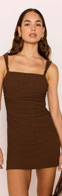Brown Ruched Mini Dress with Bead Detail modeled by a woman, highlighting the square neckline and ruched design.