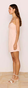Dusty Pink Linen Mini Dress With Bead Detail worn by a model, showcasing side profile in a soft blush color.