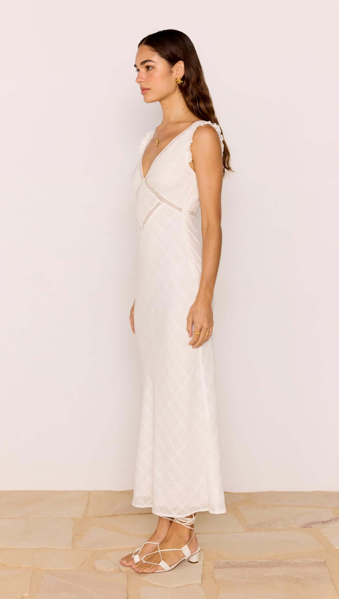 Lace Detail White Cotton Midi Dress side view showcasing its plunging V-neckline and lace trim.