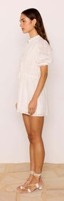 Lace Detail White Cotton Mini Dress featuring puff sleeves and lace inserts, shown in a side profile.