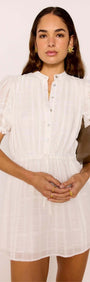 A model wearing the Lace Detail White Cotton Mini Dress with puff sleeves and lace details, styled with a chic handbag.