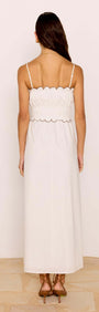 Back view of the Scallop Edge Cotton White Midi Dress showcasing its delicate scalloped hem and shirred bodice.
