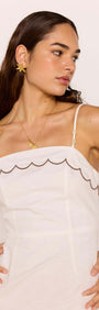 Scallop Edge Cotton White Mini Dress worn by model with scalloped neckline and adjustable straps.