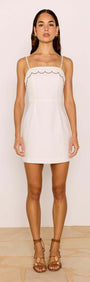 Scallop Edge Cotton White Mini Dress featuring adjustable straps and scalloped neckline for a chic summer look.