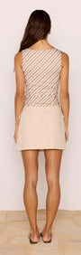 Back view of a model wearing the Brown & Cream Stripe Mesh Top with a fitted silhouette paired with a beige skirt.