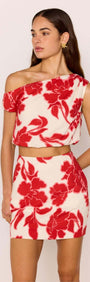 Red & White Floral Linen Blend Asymmetric Crop Top worn with matching skirt, showcasing bold floral print and stylish design.