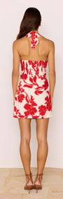 Back view of the Red & White Floral Linen Blend Halter-Neck Mini Dress showcasing a bold floral print and open back design.