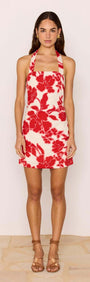 Red & White Floral Linen Blend Halter-Neck Mini Dress modeled by a woman, showcasing a bold floral print on a summer dress.